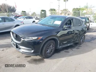 2021 Mazda CX-5 Touring with VIN JM3KFACM2M0339349, listed as a IAAI auction lot 41651005 with 53,792 mi miles. Bid and sale history available at carsss.com. Image 19.