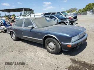 1992 Jaguar XJ with VIN SAJHY174XNC649368, listed as a Copart auction lot 50191454 with 99,553 mi miles and Salvage Title. Bid and sale history available at DreamBid. Image 4.