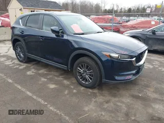 2021 Mazda CX-5 Touring with VIN JM3KFBCM7M1380396, listed as a IAAI auction lot 41707612 with 55,555 mi miles. Bid and sale history available at carsss.com. Image 1.