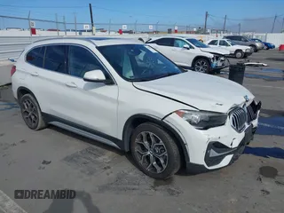 2021 BMW X1 sDrive28i with VIN WBXJG7C00M5S02921, listed as a IAAI auction lot 41809270 with 54,679 mi miles. Bid and sale history available at carsss.com. Image 1.