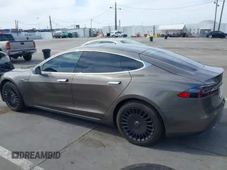 2015 Tesla Model S 85 with VIN 5YJSA1E14FF120455, listed as a IAAI auction lot 42053306 with 62,817 mi miles and . Bid and sale history available at DreamBid. Image 14.