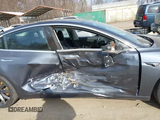 2018 Tesla Model 3 Long Range Battery with VIN 5YJ3E1EB5JF063077, listed as a IAAI auction lot 41773551 with 99,477 mi miles and . Bid and sale history available at DreamBid. Image 6.