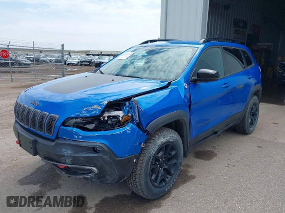 2022 Jeep Cherokee Trailhawk z VIN 1C4PJMBX4ND513488, wystawiony jako IAAI lot #42137114 z przebiegiem 12 306 mil mil oraz . Historia ofert i sprzedaży dostępna na DreamBid. Obrazek 2.