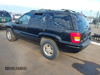 1999 Jeep Grand Cherokee Limited with VIN 1J4GW68NXXC637464, listed as a IAAI auction lot 41561690 with 235,728 mi miles. Bid and sale history available at carsss.com. Image 3.