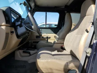 1999 Jeep Wrangler Sport with VIN 1J4FY19S6XP445867, listed as a Copart auction lot 62223125 with 146,037 mi miles and Salvage title. Bid and sale history available at DreamBid. Image 7.