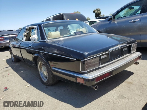 1990 Jaguar XJ with VIN SAJKY1745LC622713, listed as a Copart auction lot 56545414 with Not Provided miles and Salvage Title. Bid and sale history available at DreamBid. Image 2.