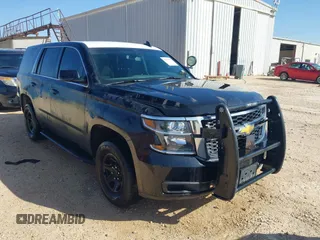 2015 Chevrolet Tahoe Commercial z VIN 1GNLC2EC7FR575386, wystawiony jako IAAI lot #41836137 z przebiegiem 143 231 mil mil oraz . Historia ofert i sprzedaży dostępna na DreamBid. Obrazek 1.
