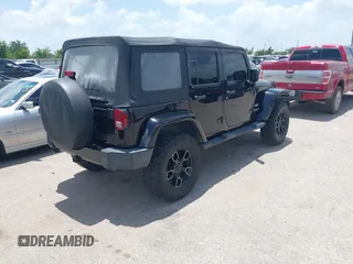 2015 Jeep Wrangler Unlimited Sahara with VIN 1C4HJWEG6FL572674, listed as a IAAI auction lot 42736266 with 97,024 mi miles and . Bid and sale history available at DreamBid. Image 4.