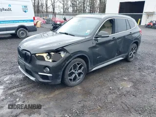 2018 BMW X1 xDrive28i with VIN WBXHT3C34J5K31430, listed as a IAAI auction lot 41954792 with 125,447 mi miles. Bid and sale history available at carsss.com. Image 2.