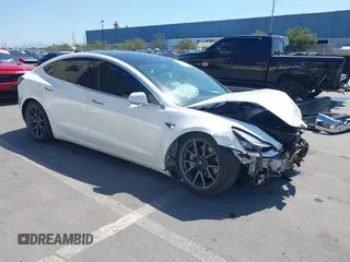 2020 Tesla Model 3 Standard Range Plus with VIN 5YJ3E1EAXLF590591, listed as a IAAI auction lot 42140338 with 79,342 mi miles and . Bid and sale history available at DreamBid. Image 1.