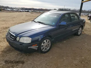 2005 Kia Optima LX z VIN KNAGD128955423159, wystawiony jako Copart lot #84280734 z przebiegiem 92 428 mil mil oraz Szkoda całkowita • Salvage title. Historia ofert i sprzedaży dostępna na DreamBid. Obrazek 1.