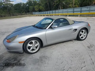 1999 Porsche Boxster z VIN WP0CA2989XU632447, wystawiony jako Copart lot #55998015 z przebiegiem 60 275 mil mil oraz Czysty tytuł • Clean title. Historia ofert i sprzedaży dostępna na DreamBid. Obrazek 1.
