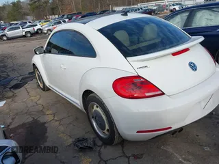 2014 Volkswagen Beetle 2.5L w/Sun with VIN 3VWJP7ATXEM628666, listed as a IAAI auction lot 41328014 with 70,990 mi miles and . Bid and sale history available at DreamBid. Image 3.