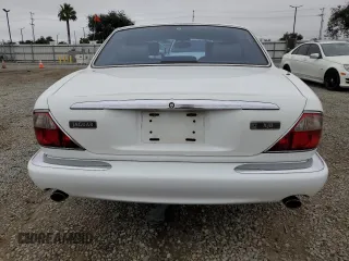 1999 Jaguar XJ with VIN SAJHX1040XC864208, listed as a Copart auction lot 59748585 with 130,577 mi miles and Clean title. Bid and sale history available at DreamBid. Image 6.