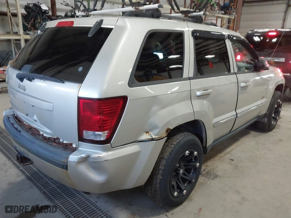 2010 Jeep Grand Cherokee Laredo with VIN 1J4PR4GK9AC160097, listed as a IAAI auction lot 41883264 with 240,409 mi miles. Bid and sale history available at carsss.com. Image 4.