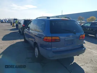 1999 Toyota Sienna LE with VIN 4T3ZF13C2XU126738, listed as a IAAI auction lot 41012127 with 218,080 mi miles. Bid and sale history available at carsss.com. Image 3.