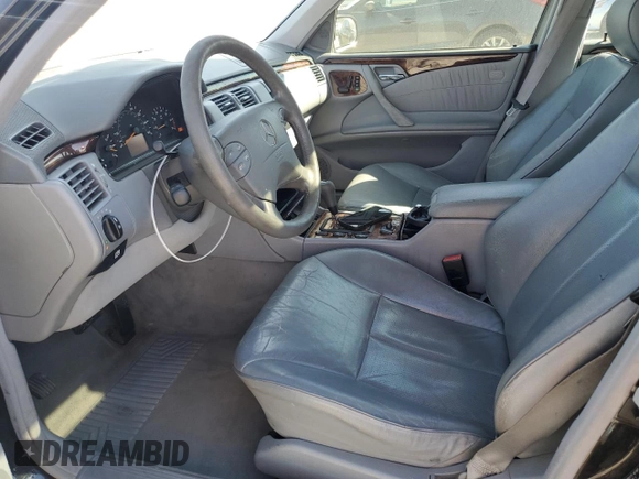 2000 Mercedes-Benz E-Class with VIN WDBJF70JXYB091085, listed as a Copart auction lot 77136484 with 185,429 mi miles and Salvage Title. Bid and sale history available at carsss.com. Image 7.