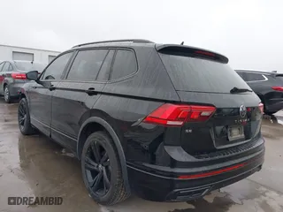 2023 Volkswagen Tiguan SE R-Line Black with VIN 3VVCB7AX0PM061742, listed as a IAAI auction lot 41528630 with 22,571 mi miles. Bid and sale history available at carsss.com. Image 3.