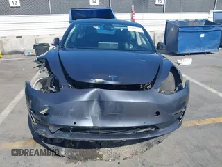 2022 Tesla Model 3 with VIN 5YJ3E1EA1NF142713, listed as a IAAI auction lot 42027630 with 112,557 mi miles. Bid and sale history available at carsss.com. Image 11.