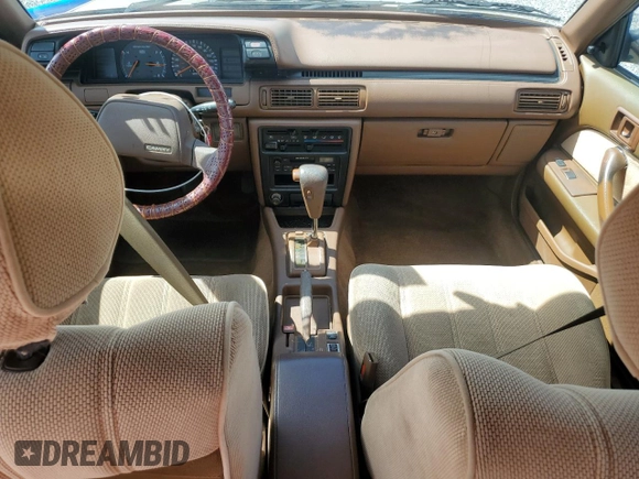 1991 Toyota Camry DLX z VIN 4T1SV21E5MU415356, wystawiony jako Copart lot #74465914 z przebiegiem 74 592 mil mil oraz Szkoda całkowita • Salvage title. Historia ofert i sprzedaży dostępna na DreamBid. Obrazek 8.