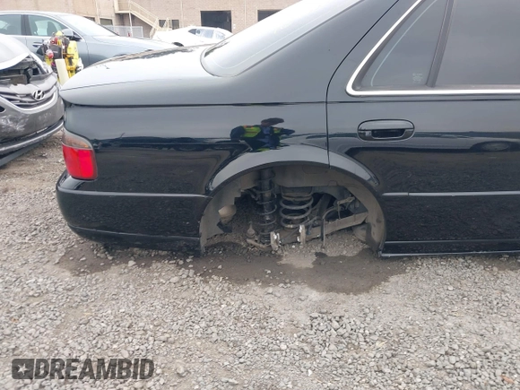 2002 Cadillac Seville Touring STS z VIN 1G6KY54982U239673, wystawiony jako IAAI lot #41657709 z przebiegiem 92 224 mil mil oraz . Historia ofert i sprzedaży dostępna na DreamBid. Obrazek 6.