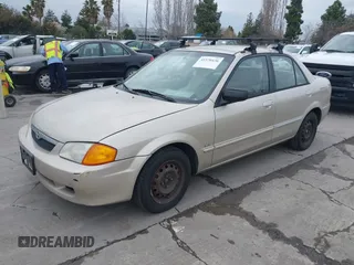 2000 Mazda Protege DX with VIN JM1BJ2223Y0212144, listed as a IAAI auction lot 41570436 with 221,430 mi miles and . Bid and sale history available at DreamBid. Image 2.