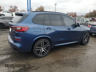 2020 BMW X5 M50i with VIN 5UXJU4C07LLE46002, listed as a Copart auction lot 77853984 with 74,098 mi miles and Salvage Title. Bid and sale history available at DreamBid. Image 3.