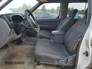 2000 Nissan Frontier XE with VIN 1N6ED27T1YC385792, listed as a Copart auction lot 62268225 with 291,906 mi miles and Salvage title. Bid and sale history available at DreamBid. Image 7.