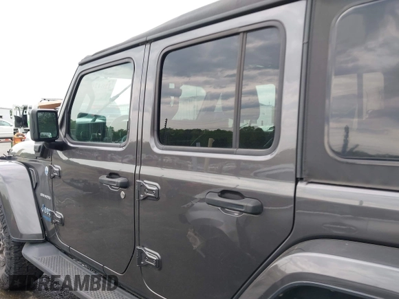 2021 Jeep Wrangler Unlimited Sahara with VIN 1C4JJXP60MW704738, listed as a IAAI auction lot 42042079 with 63,765 mi miles and . Bid and sale history available at DreamBid. Image 14.