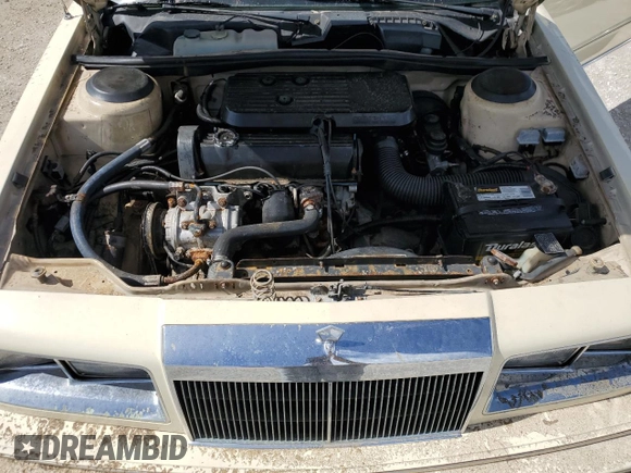 1986 Chrysler LeBaron z VIN 1C3BC55D0GG153072, wystawiony jako Copart lot #77865854 z przebiegiem 74 922 mil mil oraz Szkoda całkowita • Salvage title. Historia ofert i sprzedaży dostępna na DreamBid. Obrazek 11.