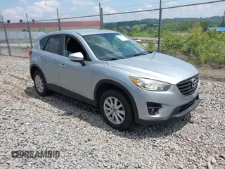 2016 Mazda CX-5 Touring z VIN JM3KE4CY5G0603238, wystawiony jako IAAI lot #42469964 z przebiegiem 374 182 mil mil oraz . Historia ofert i sprzedaży dostępna na DreamBid. Obrazek 1.