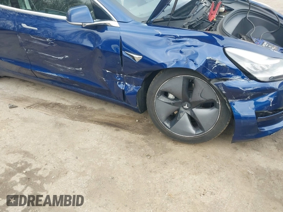 2019 Tesla Model 3 Mid Range with VIN 5YJ3E1EA5KF299589, listed as a IAAI auction lot 41709733 with 50,256 mi miles and . Bid and sale history available at DreamBid. Image 6.