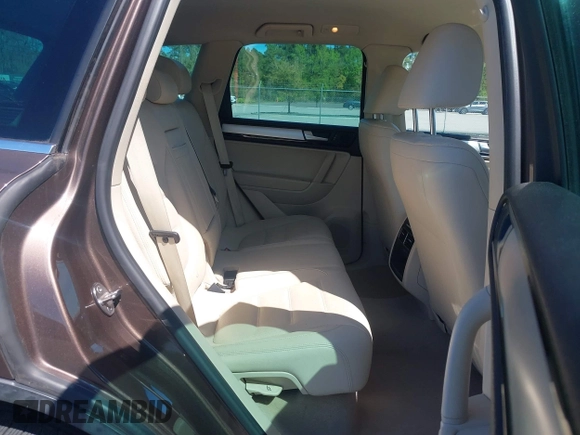 2014 Volkswagen Touareg Sport with VIN WVGEF9BP7ED003525, listed as a IAAI auction lot 41868307 with 74,379 mi miles and . Bid and sale history available at DreamBid. Image 8.