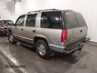 1999 GMC Yukon with VIN 1GKEK13R7XJ723255, listed as a IAAI auction lot 41879617 with 148,324 mi miles. Bid and sale history available at carsss.com. Image 3.