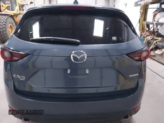 2021 Mazda CX-5 Touring z VIN JM3KFBCM4M0459465, wystawiony jako IAAI lot #41059836 z przebiegiem 74 645 mil mil oraz . Historia ofert i sprzedaży dostępna na DreamBid. Obrazek 17.
