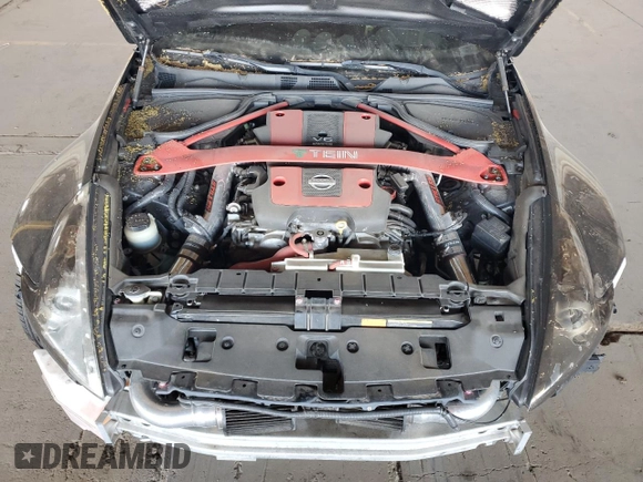 2009 Nissan 370Z z VIN JN1AZ44E19M411715, wystawiony jako Copart lot #56654815 z przebiegiem 123 791 mil mil oraz Szkoda całkowita • Salvage title. Historia ofert i sprzedaży dostępna na DreamBid. Obrazek 11.