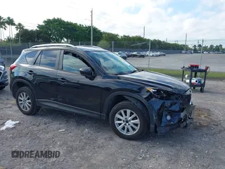 2014 Mazda CX-5 Touring with VIN JM3KE2CYXE0384987, listed as a IAAI auction lot 42052196 with 151,765 mi miles. Bid and sale history available at carsss.com. Image 1.