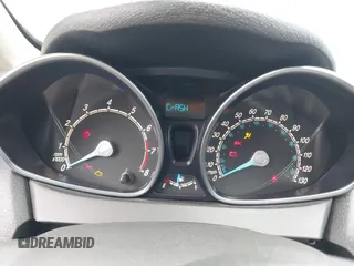 2014 Ford Fiesta SE z VIN 3FADP4BJ0EM216922, wystawiony jako IAAI lot #42255776 z przebiegiem 87 371 mil mil oraz . Historia ofert i sprzedaży dostępna na DreamBid. Obrazek 7.