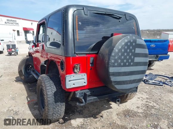 2002 Jeep Wrangler Sport with VIN 1J4FA49S42P771262, listed as a IAAI auction lot 41819403 with 132,871 mi miles. Bid and sale history available at carsss.com. Image 3.