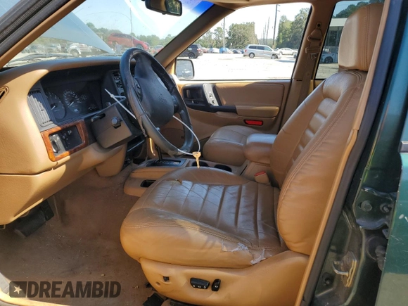 1998 Jeep Grand Cherokee with VIN 1J4FX48S8WC281615, listed as a Copart auction lot 77305594 with 128,393 mi miles and Salvage title. Bid and sale history available at DreamBid. Image 7.