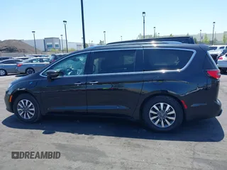 2021 Chrysler Pacifica Hybrid Touring L with VIN 2C4RC1L71MR599631, listed as a IAAI auction lot 42151965 with 67,401 mi miles and . Bid and sale history available at DreamBid. Image 14.