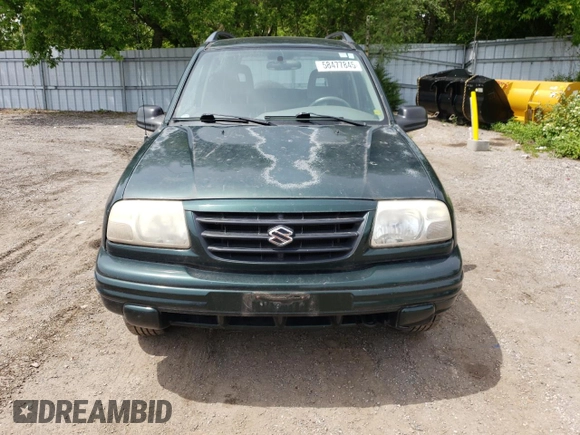 2003 Suzuki Vitara JLX z VIN 2S3TD52V136101732, wystawiony jako Copart lot #58477845 z przebiegiem 105 628 mil mil oraz Czysty tytuł • Clean title. Historia ofert i sprzedaży dostępna na DreamBid. Obrazek 5.