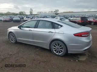 2017 Ford Fusion Hybrid SE z VIN 3FA6P0LU4HR384645, wystawiony jako Copart lot #56454995 z przebiegiem 165 322 mil mil oraz Czysty tytuł • Clean title. Historia ofert i sprzedaży dostępna na DreamBid. Obrazek 2.