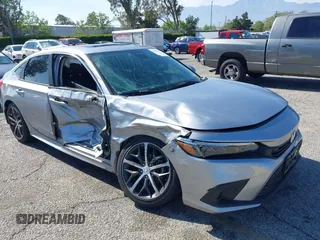 2023 Honda Civic Touring with VIN 2HGFE1F91PH315520, listed as a IAAI auction lot 42162698 with 33,227 mi miles and . Bid and sale history available at DreamBid. Image 1.