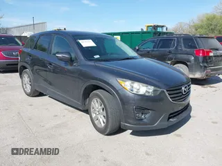 2016 Mazda CX-5 Touring z VIN JM3KE2CY4G0708972, wystawiony jako IAAI lot #42043013 z przebiegiem 157 573 mil mil oraz . Historia ofert i sprzedaży dostępna na DreamBid. Obrazek 1.