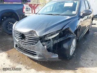 2016 Mazda CX-5 Touring with VIN JM3KE4CY3G0672977, listed as a IAAI auction lot 41889137 with 130,593 mi miles. Bid and sale history available at carsss.com. Image 6.