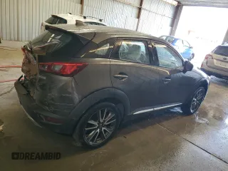 2016 Mazda CX-3 Grand Touring z VIN JM1DKFD74G0137815, wystawiony jako Copart lot #52405765 z przebiegiem 128 922 mil mil oraz Szkoda całkowita • Salvage title. Historia ofert i sprzedaży dostępna na DreamBid. Obrazek 3.