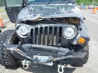 2003 Jeep Wrangler Sport z VIN 1J4FA49S53P317779, wystawiony jako IAAI lot #42388780 z przebiegiem Nie podano mil oraz . Historia ofert i sprzedaży dostępna na DreamBid. Obrazek 11.