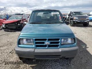 1996 Chevrolet Tracker z VIN 2CNBJ1869T6903615, wystawiony jako Copart lot #49690055 z przebiegiem 144 821 mil mil oraz Szkoda całkowita • Salvage title. Historia ofert i sprzedaży dostępna na DreamBid. Obrazek 5.