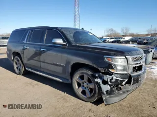 2015 Chevrolet Suburban LT with VIN 1GNSKJKC2FR274506, listed as a Copart auction lot 87881695 with 196,506 mi miles and Salvage Title. Bid and sale history available at DreamBid. Image 4.